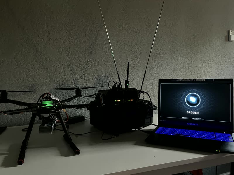 A DaggerOS field kit: a sensing airframe, a ground-station radio pack, and DaggerOS booting on a commodity laptop.